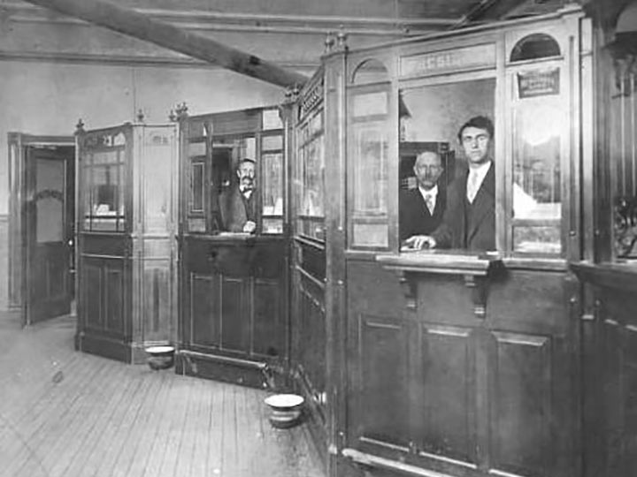 bank employees behind counters in early 1900s